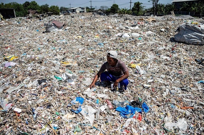 A Bangun resident sorts plastic waste